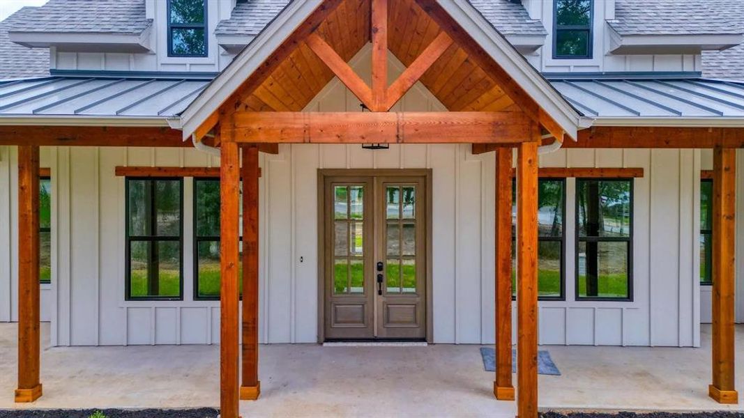 Doorway to property with covered porch