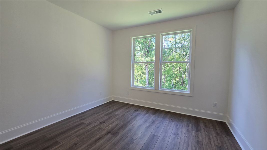 Hardwood-style flooring extends through this airy