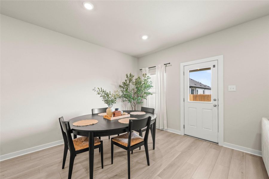 Recessed lighting illuminates this dining space with durable flooring and convenient exterior access. Recessed lighting illuminates this dining space with durable flooring and convenient exterior access.