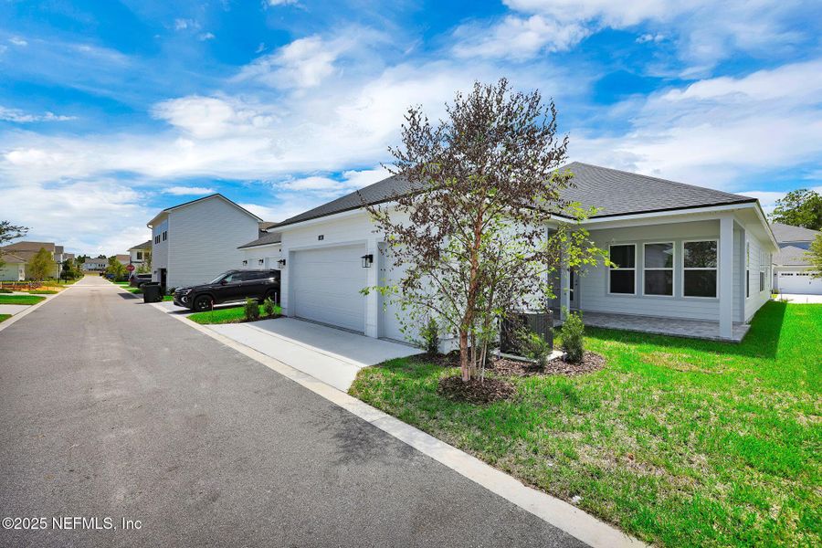 Front exterior of a new home in Seabrook Village at Seabrook, Ponte Vedra, FL, highlighting curb appeal (Image 24).