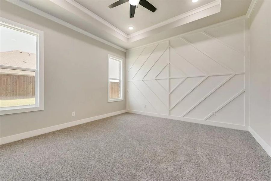 Carpeted empty room with a decorative wall, a ceiling fan, ornamental molding, and recessed lighting