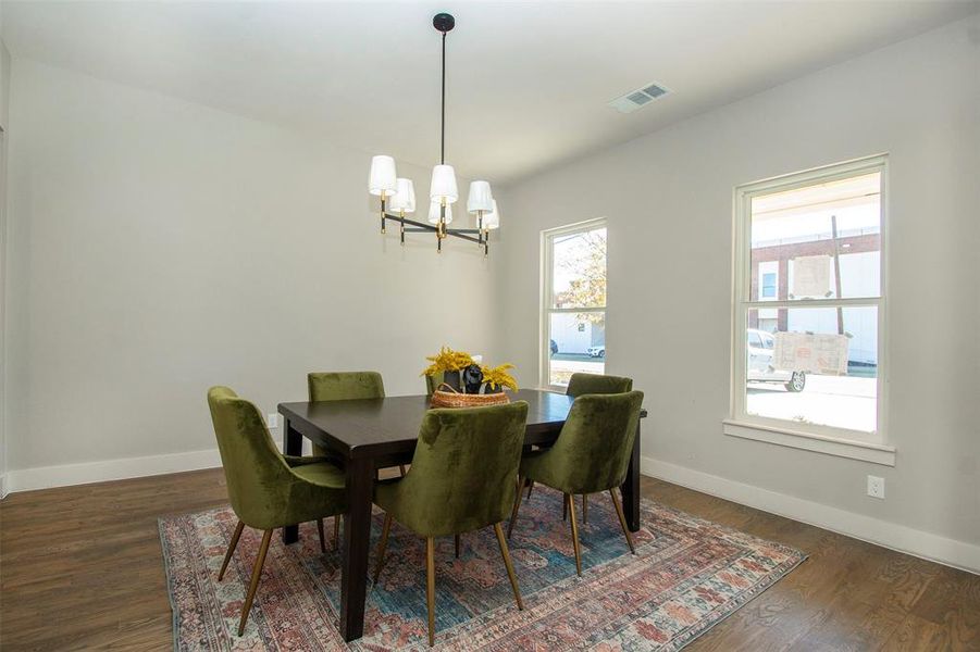 Dining room featuring a notable chandelier and dark hardwood / wood-style flooring