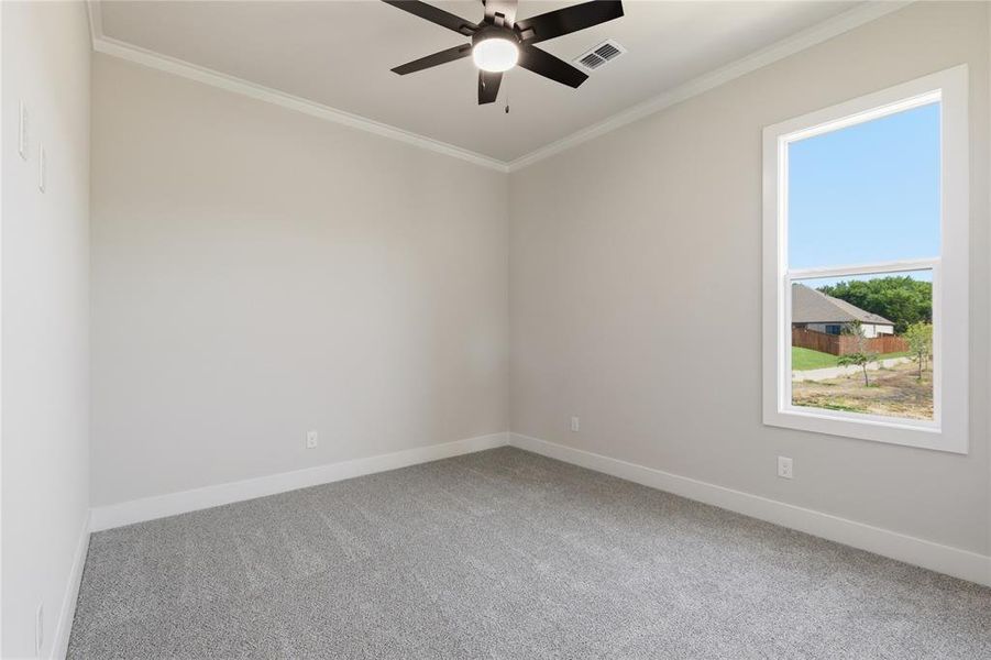 Room featuring neutral wall tones, gray carpeting, a single window with white trim, a ceiling fan with light fixture, and white baseboards