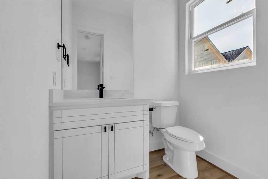 Take a closer look at the half bath,featuring a large glass window thatbrings in natural light. Take a closer look at the half bath,featuring a large glass window thatbrings in natural light.