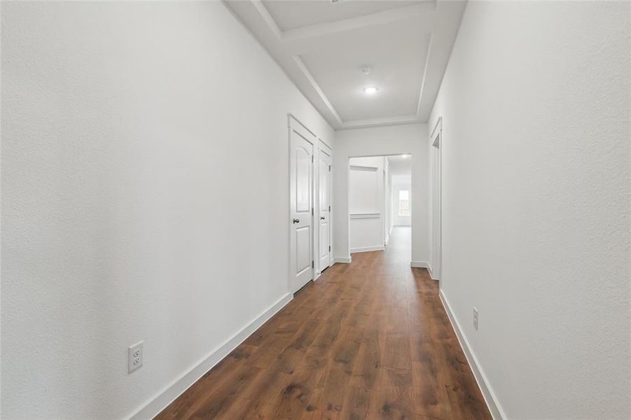 Hall with baseboards and dark wood finished floors Hall with baseboards and dark wood finished floors