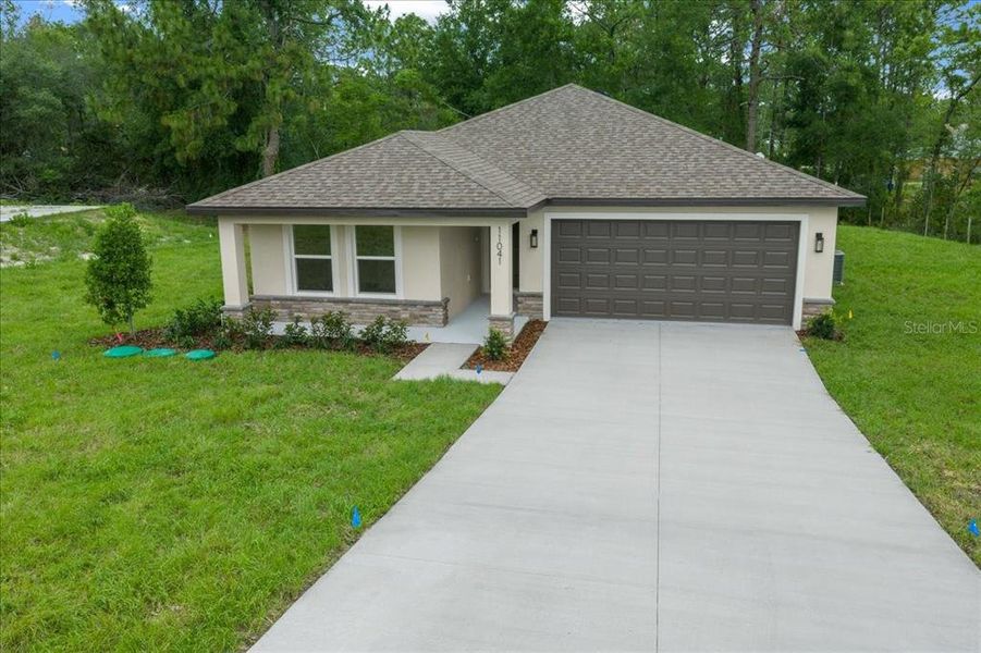 Front exterior of a new home in , Weeki Wachee, FL, highlighting curb appeal (Image 26).