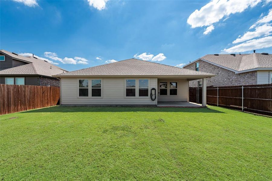 Back of property with a patio area, a fenced backyard, and roof with shingles Back of property with a patio area, a fenced backyard, and roof with shingles