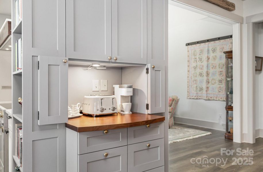 Beautiful cabinetry with walnut top - the doors open back offering a welcoming station for beverages or snacks! Beautiful cabinetry with walnut top - the doors open back offering a welcoming station for beverages or snacks!
