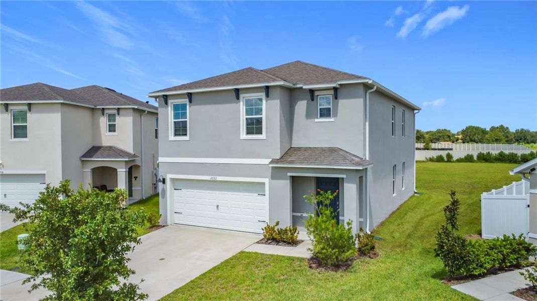 Front exterior of a new home in Harmony West, St. Cloud, FL, highlighting curb appeal (Image 2).
