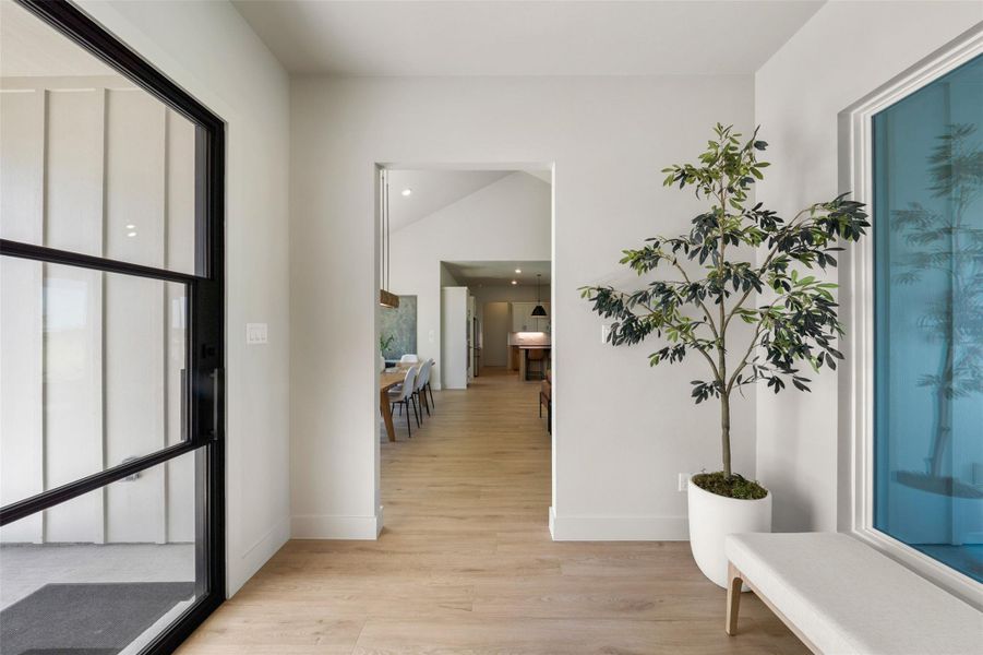Foyer featuring luxury vinyl plank floors, baseboards, recessed lighting, and vaulted ceiling Foyer featuring luxury vinyl plank floors, baseboards, recessed lighting, and vaulted ceiling