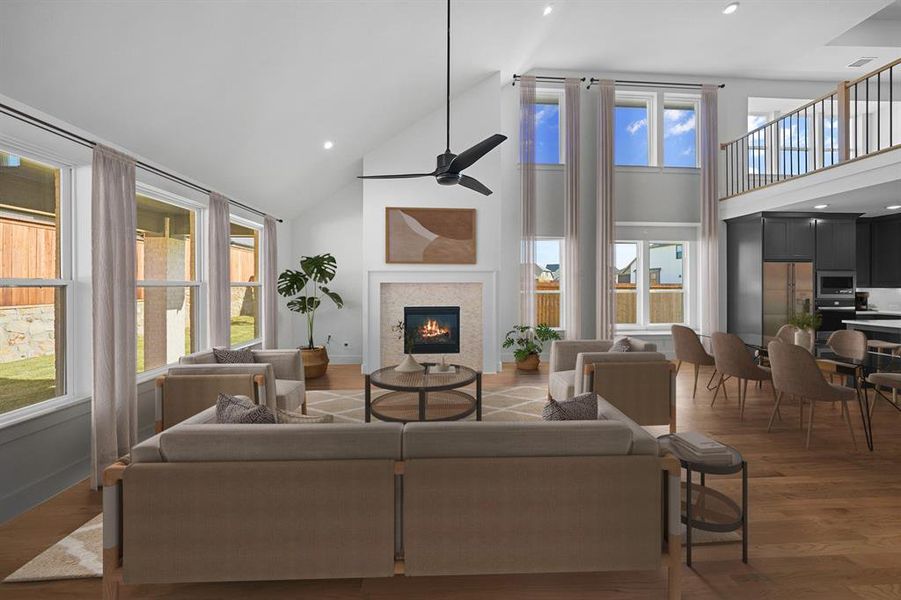 Living room with high vaulted ceiling, recessed lighting, ceiling fan, a glass covered fireplace, and dark wood-style floors Living room with high vaulted ceiling, recessed lighting, ceiling fan, a glass covered fireplace, and dark wood-style floors