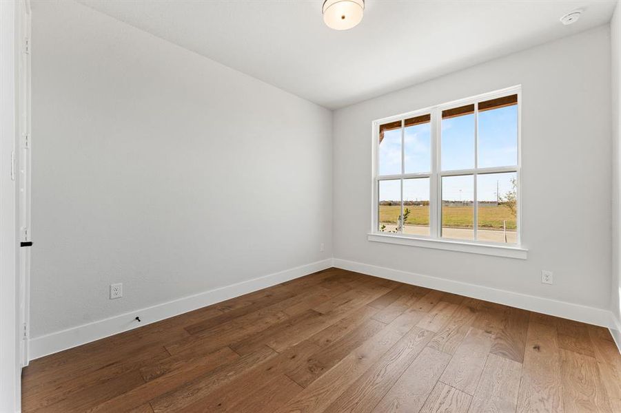 Spare room featuring hardwood / wood-style flooring