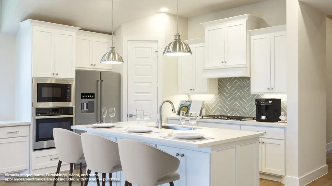 Kitchen featuring decorative backsplash, stainless steel appliances, light countertops, white cabinets, and recessed lighting Kitchen featuring decorative backsplash, stainless steel appliances, light countertops, white cabinets, and recessed lighting