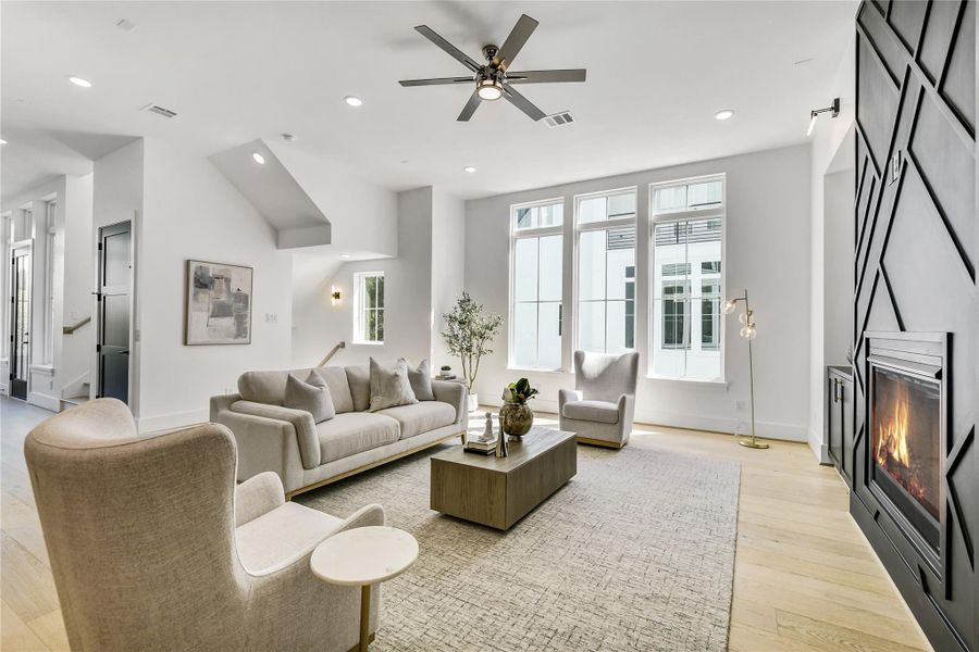 Sleek, spacious, and inviting—this open living space showcases designer lighting, floor-to-ceiling feature walls, and an effortless connection to the gourmet kitchen beyond. Every detail, from the black accent wall with hidden linear window to the recessed LED lighting and smooth drywall finish, reflects high-end craftsmanship and architectural depth. Sleek, spacious, and inviting—this open living space showcases designer lighting, floor-to-ceiling feature walls, and an effortless connection to the gourmet kitchen beyond. Every detail, from the black accent wall with hidden linear window to the recessed LED lighting and smooth drywall finish, reflects high-end craftsmanship and architectural depth.