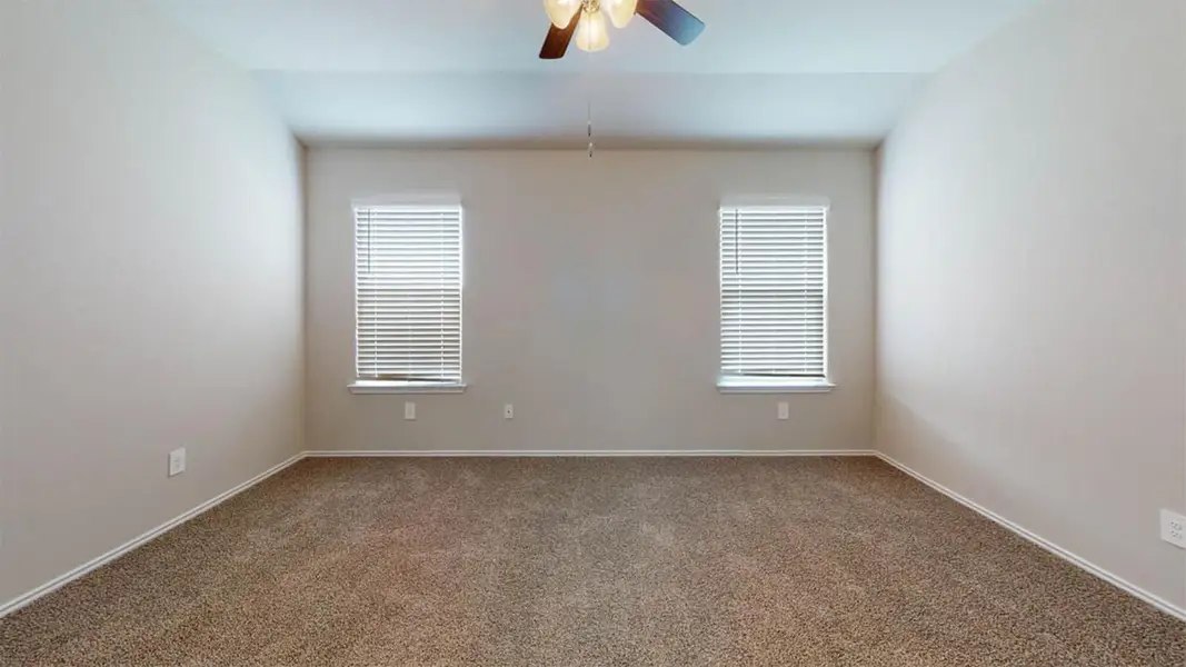 Empty room featuring carpet flooring, ceiling fan, and lofted ceiling