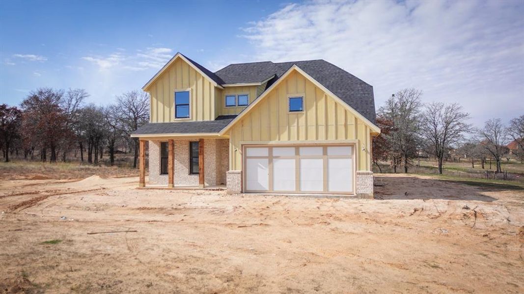 View of front of house featuring a garage and covered porch