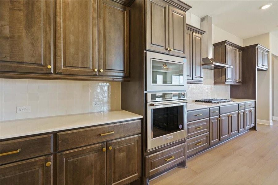 This kitchen is teeming with storage and counter space, and features upgraded golden champagne finishes.