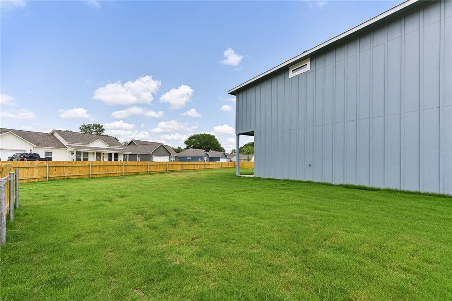View of yard featuring fence and a residential view View of yard featuring fence and a residential view