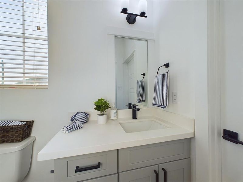 Secondary bathroom with Quartz countertops.