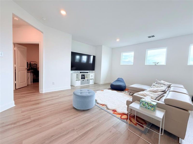 Living room featuring light wood-style flooring and recessed lighting