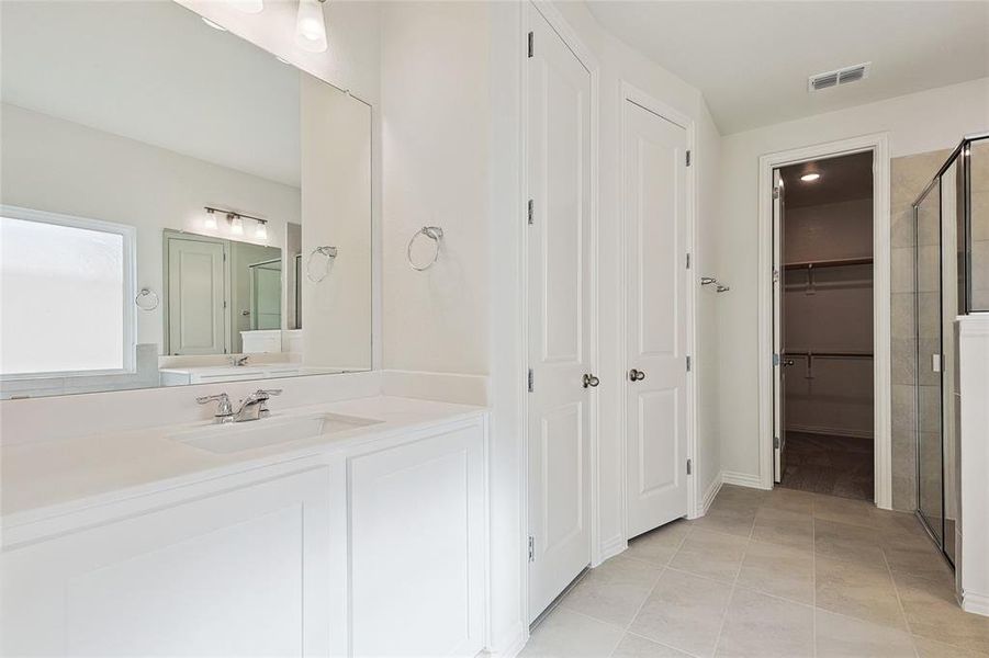 Bathroom featuring vanity and tile patterned floors