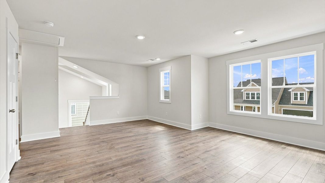 Functional loft with tasteful hardwood floors and exceptional natural light in a modern townhome