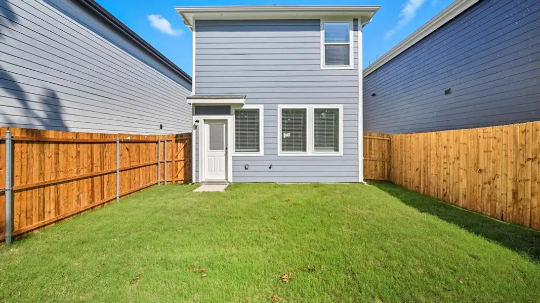Rear view of house with a fenced backyard Rear view of house with a fenced backyard