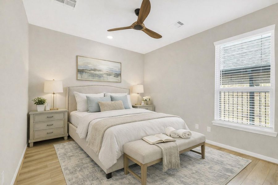 Virtually staged bedroom highlighting the room’s comfortable layout, neutral designer palette, and abundant natural light—showcasing how the space easily accommodates a full bedroom setup with room to relax.