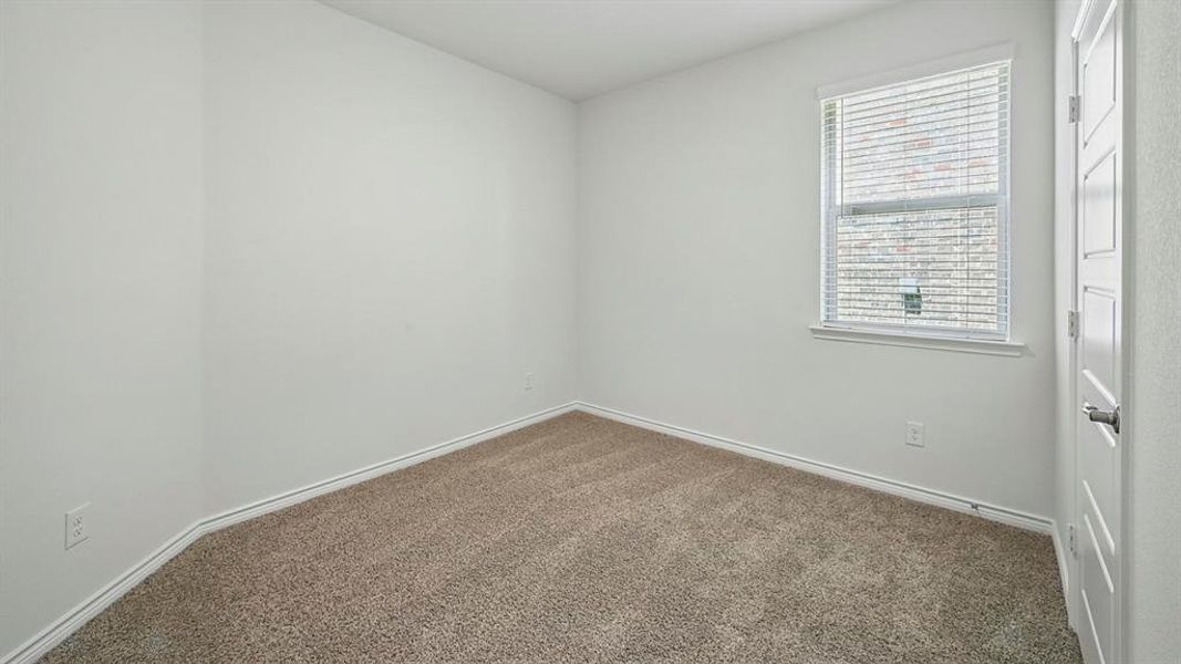 Neutral-toned wall-to-wall carpeting complements the light wall color