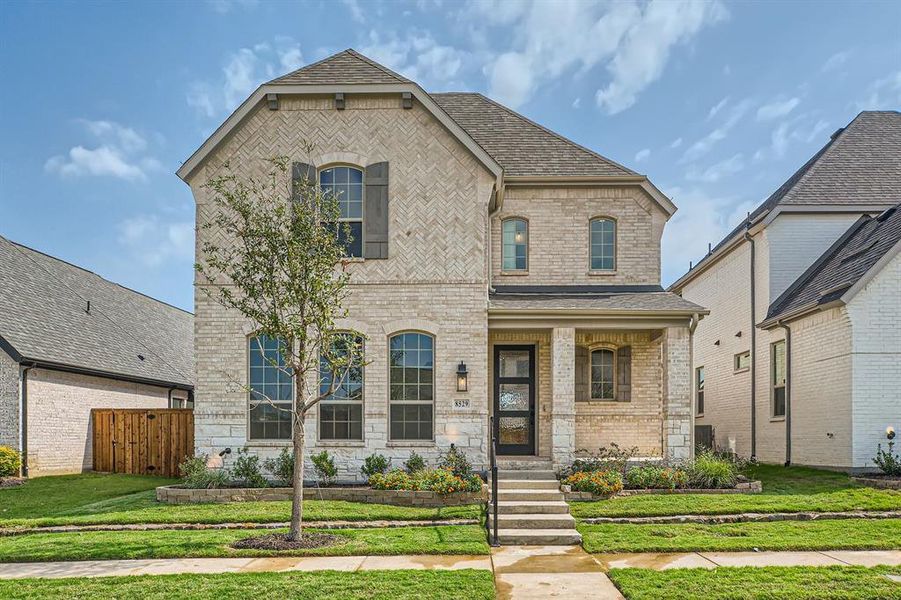 French country style house featuring a front yard