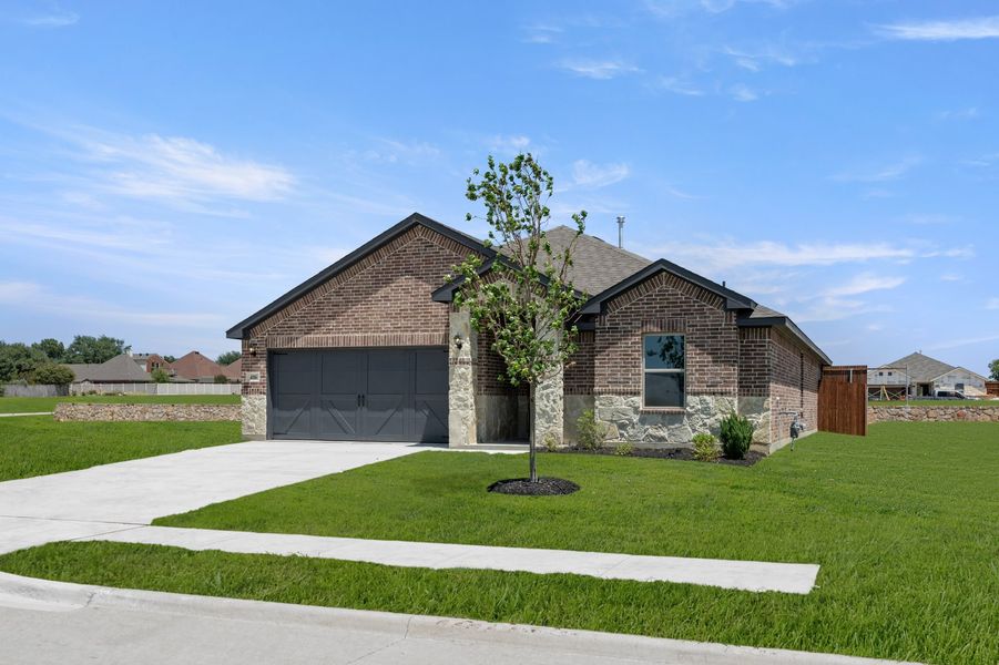 Front exterior of a new home in Baker Farms, Cleburne, TX, highlighting curb appeal (Image 2). Front exterior of a new home in Baker Farms, Cleburne, TX, highlighting curb appeal (Image 2).