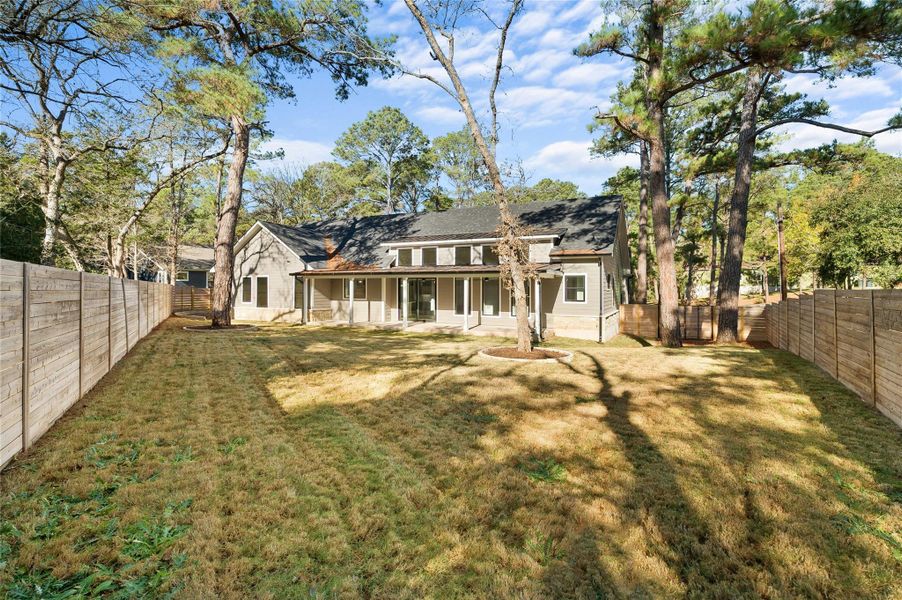 Back of property featuring a yard