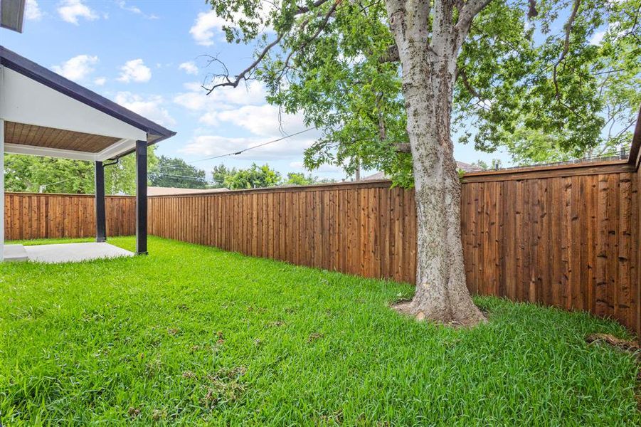 Fenced backyard with a patio area