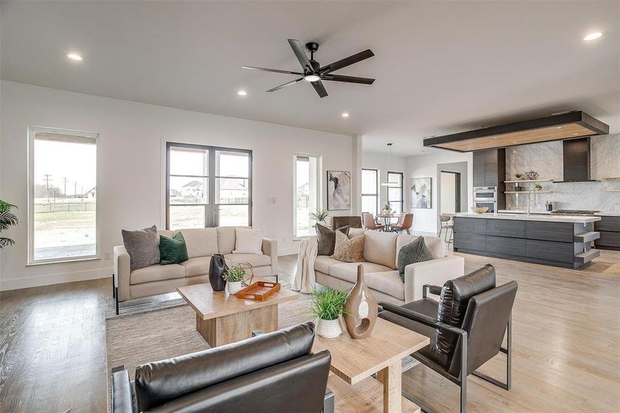 Living room featuring recessed lighting, a healthy amount of sunlight, and light wood-style flooring