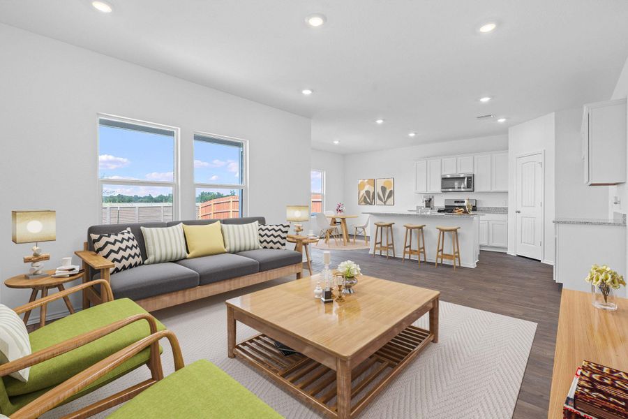 Living area with recessed lighting and dark wood-type flooring Living area with recessed lighting and dark wood-type flooring