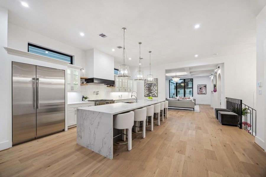 Great, open expansive space. Large Island with Breakfast Bar Seating for Six and Acoustic Slat Wood Panel Front.