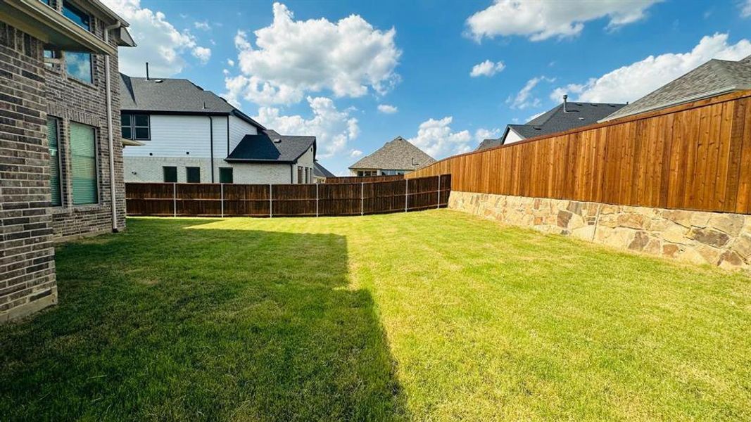 Fenced backyard with a residential view