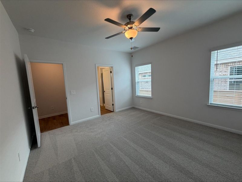 Unfurnished bedroom with carpet floors and ceiling fan