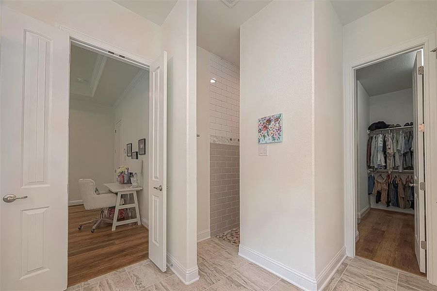 Gorgeous large doorless shower and walk-in closet in primary suite