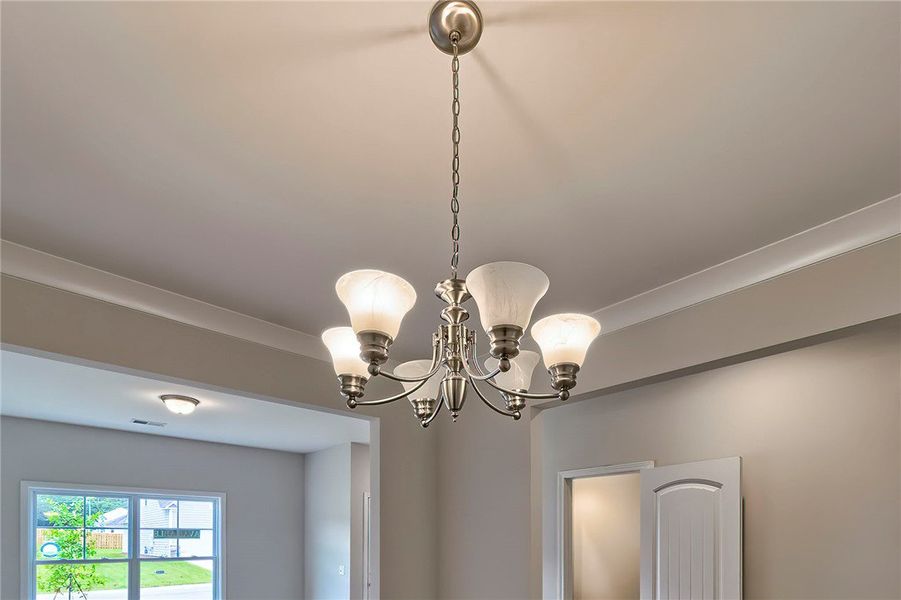 This living space features a modern chandelier, il