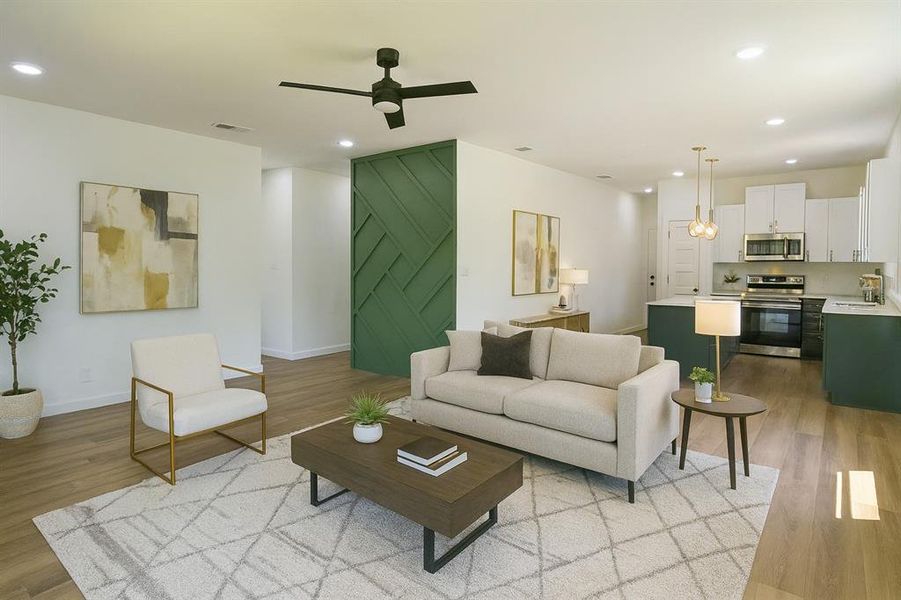 Living room featuring recessed lighting, light wood-style floors, and ceiling fan Living room featuring recessed lighting, light wood-style floors, and ceiling fan