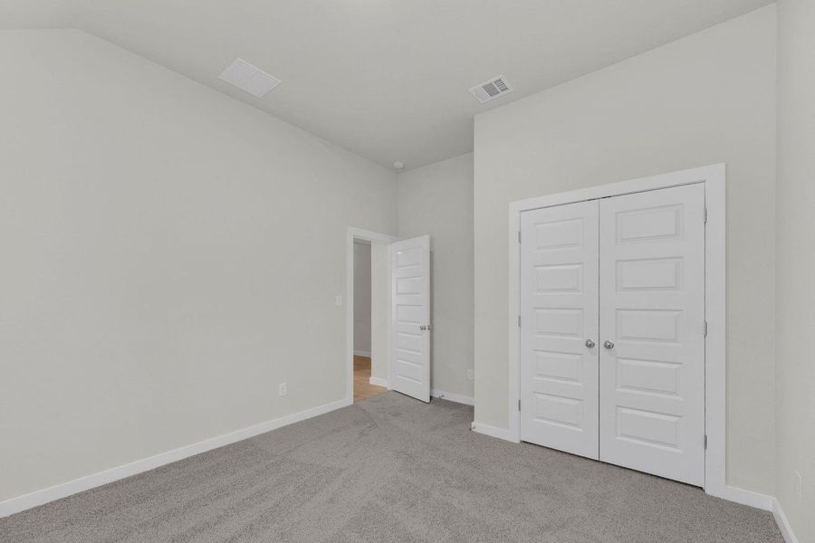 Bedroom in the Pecos home plan by Trophy Signature Homes – REPRESENTATIVE PHOTO