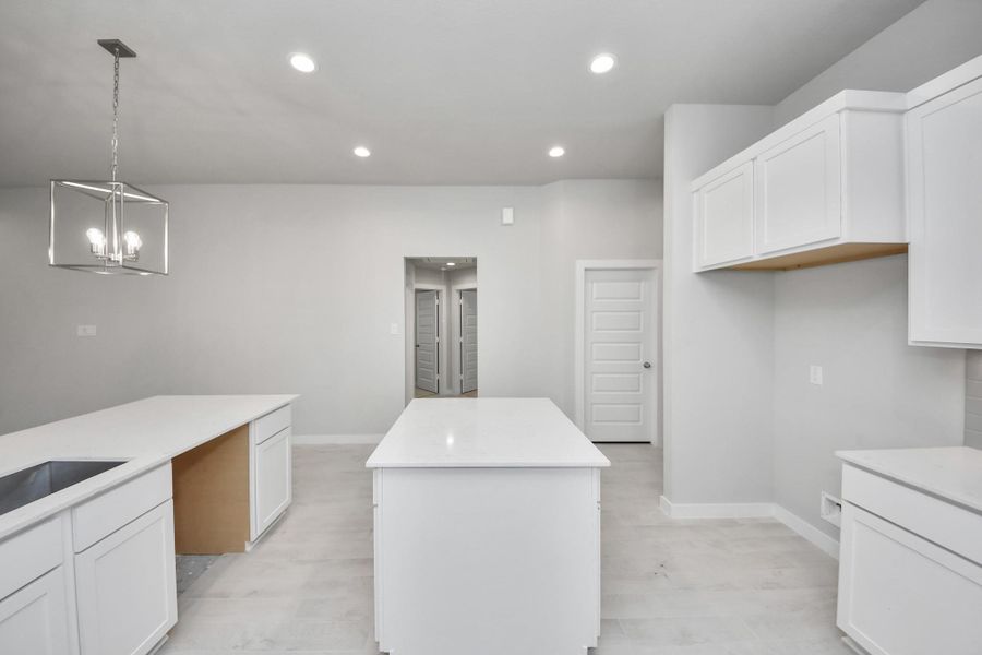 The extended counter area adds both practicality and style, making meal preparation a breeze. Every detail is thoughtfully designed to enhance the kitchen's functionality and aesthetic appeal. Sample photo of completed home with similar floor plan. Actual colors and selections may vary.