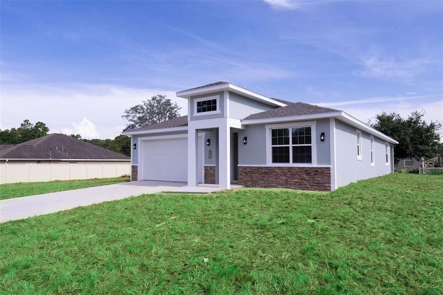 Front exterior of a new home in , Summerfield, FL, highlighting curb appeal (Image 20).