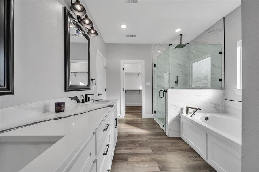 Bathroom with vanity, plus walk in shower, and wood-type flooring