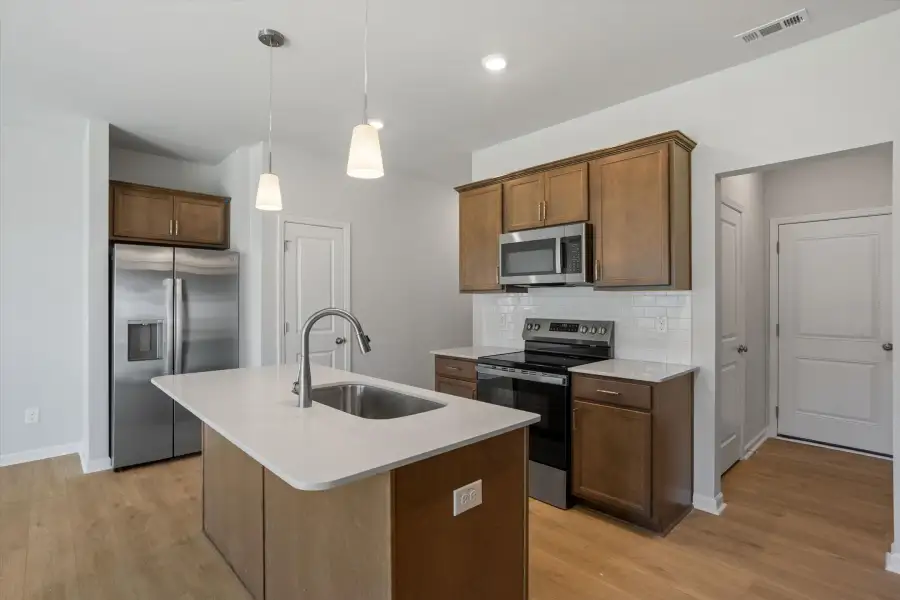 Furnished interior view inside a new home in West Main Townhomes, Sanford (Image 8).