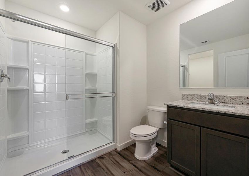 The master bath has a spacious, glass-enclosed shower.