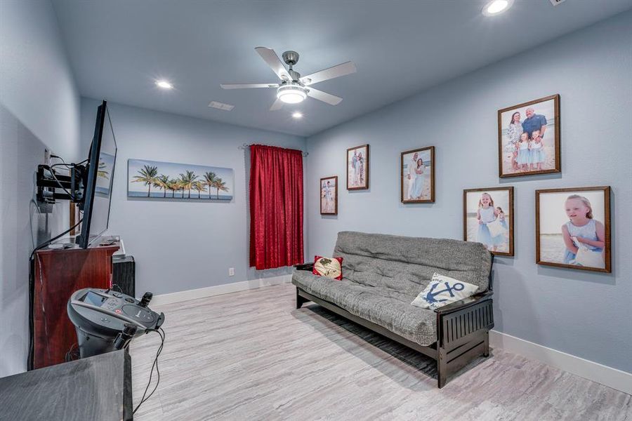 secondary bedroom with light wood-style flooring, ceiling fan, and recessed lighting