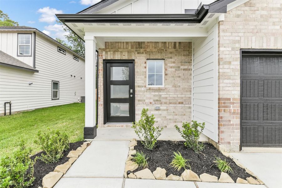Front exterior of a new home in Caney Creek Place, Conroe, TX, highlighting curb appeal (Image 63).