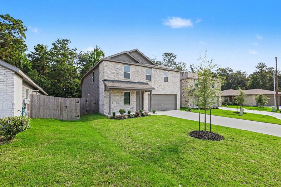 Front exterior of a new home in Hill and Dale Ranch, Splendora, TX, highlighting curb appeal (Image 2).